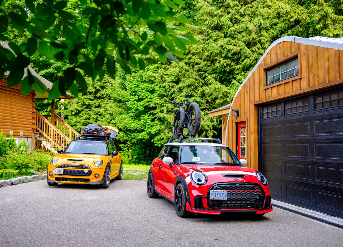 Tiny, Ontario, Canada- July 15, 2024. Two MINI COOPER cars on Muskoka cottgae vacation. Mid summer day. This is the third generation model F56 JCW width=